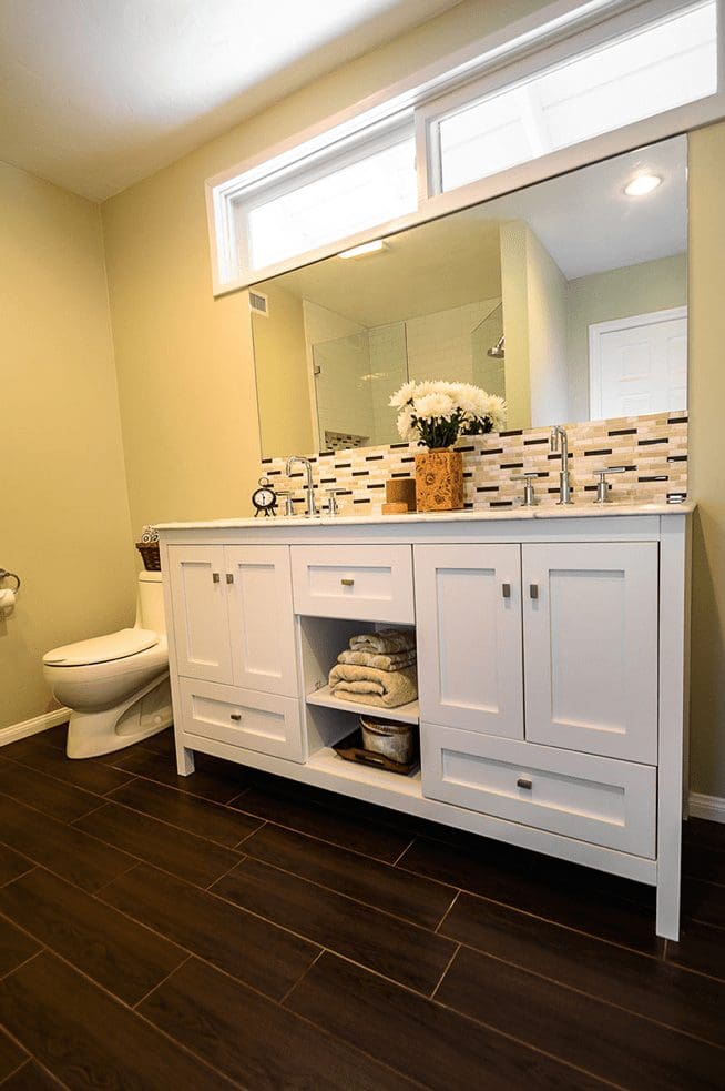 white double sink vanity next to toilet
